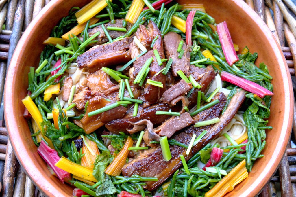 Wild spice-braised pork belly with rainbow chard and sea arrow grass